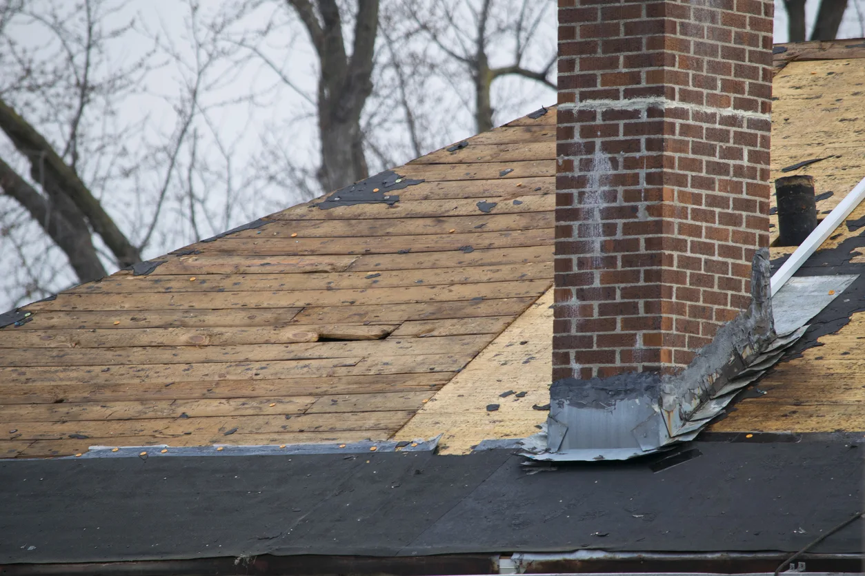 Damaged and old roofing shingles on a house